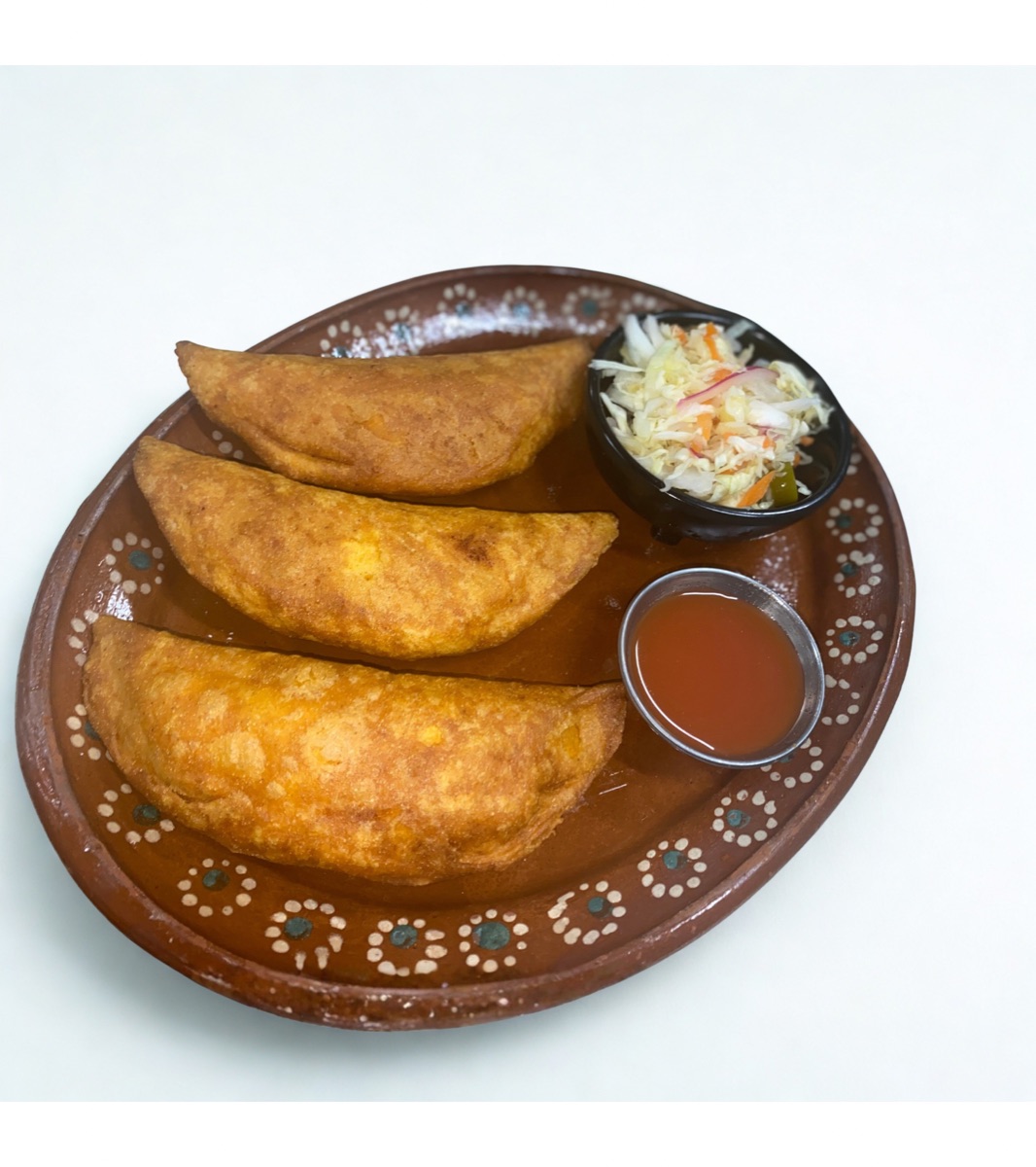 Pasteles de pollo on traditional plate