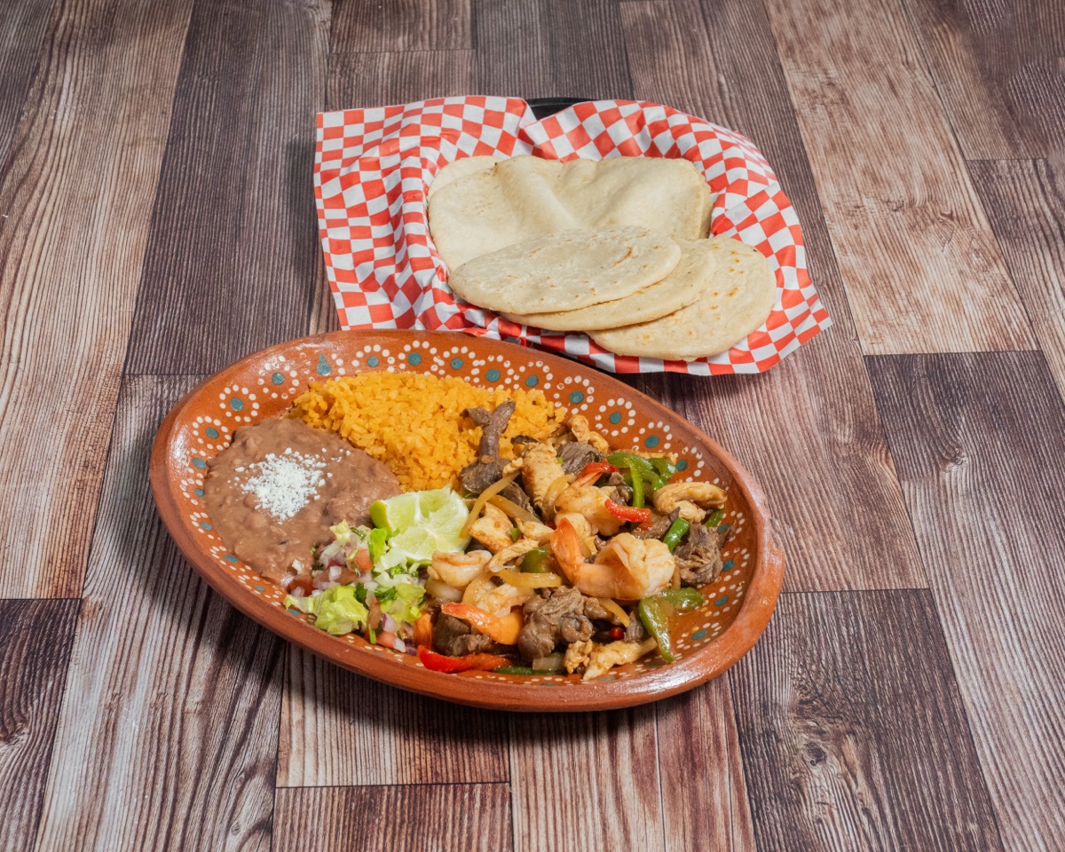 Fajitas Trio — sizzling steak, chicken, shrimp